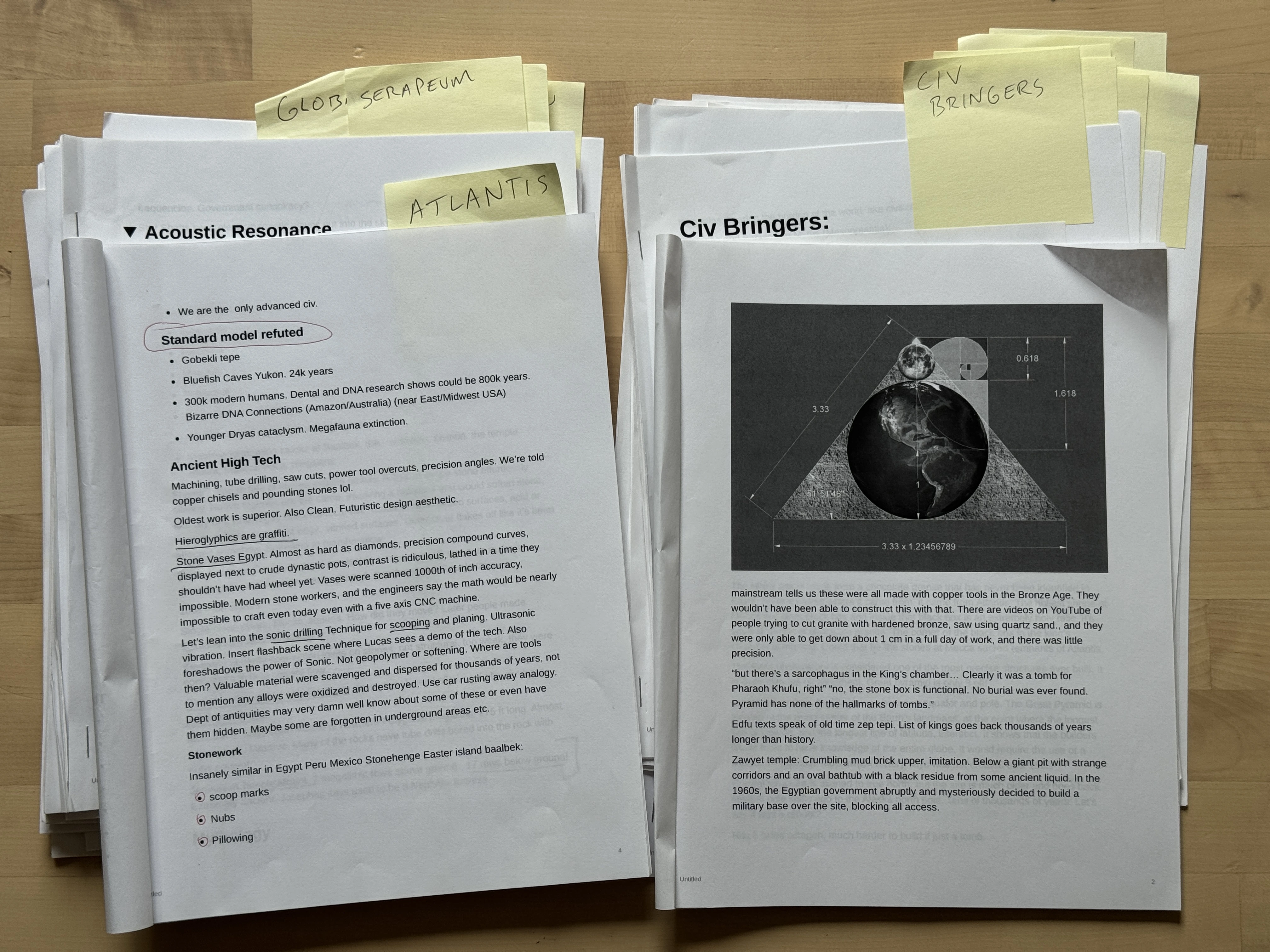 Two stacks of physical research packets labeled Atlantis and Civilization Bringers